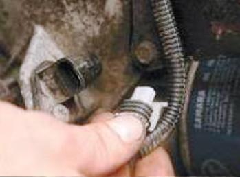 Disconnect the wiring harness from the crankshaft position sensor